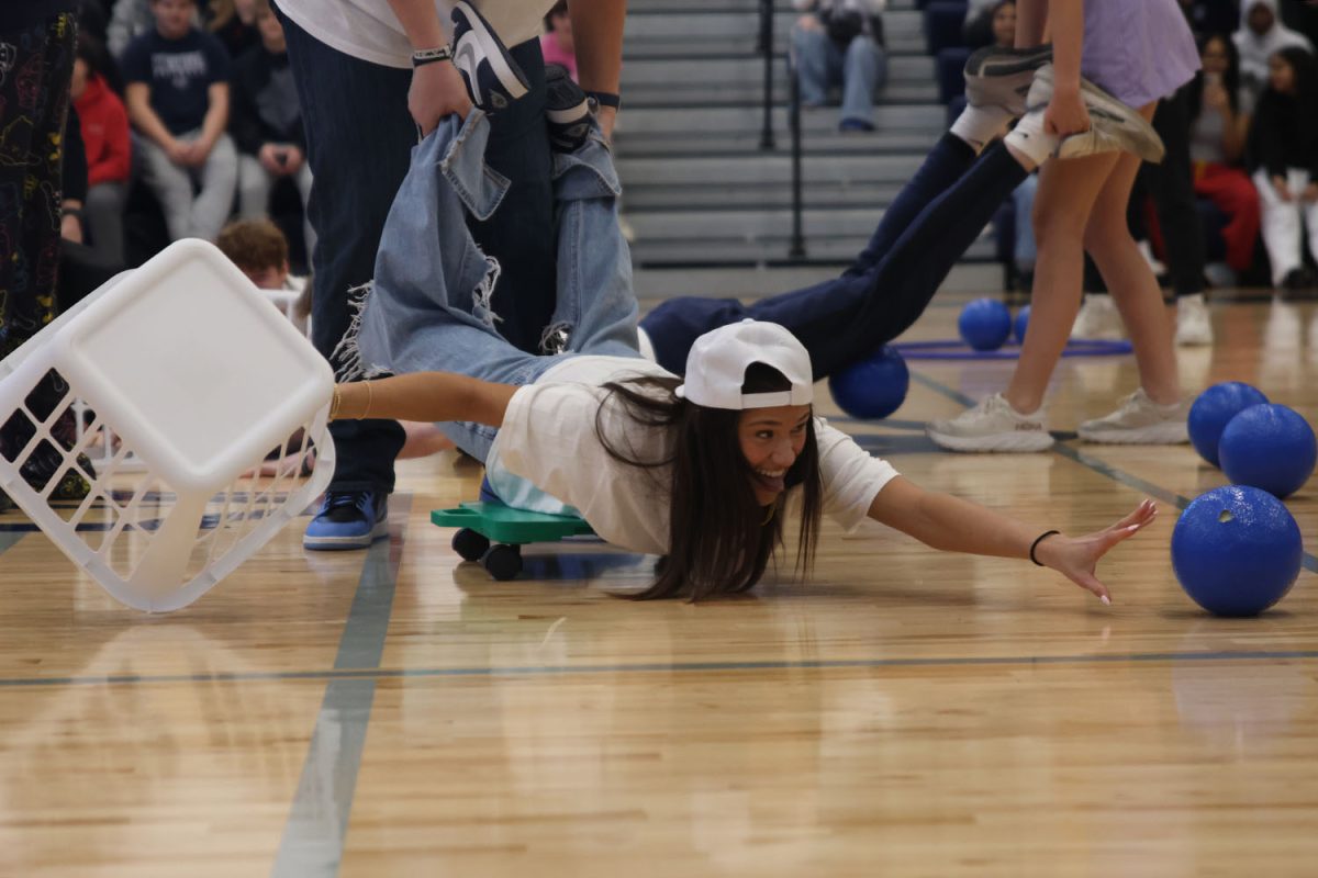 Reaching for a ball, senior Emersyn Jones competes in the candidate game.