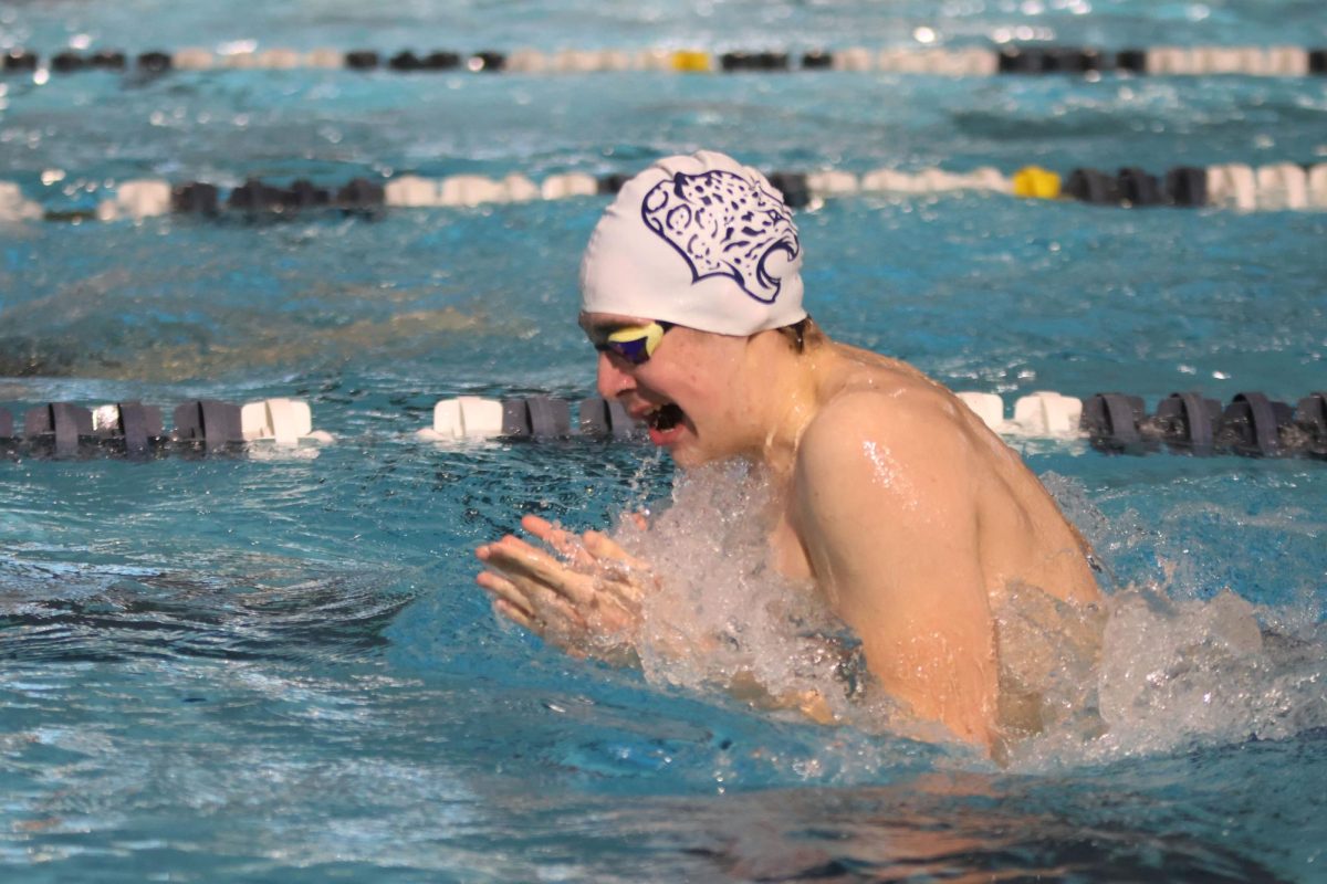 Treading through the water, senior Carson Reynolds completes his 100 meter breaststroke. 

