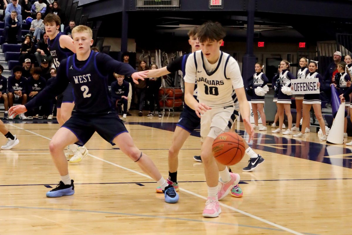 Moving down court, junior Jack Carpenter dribbles the ball.