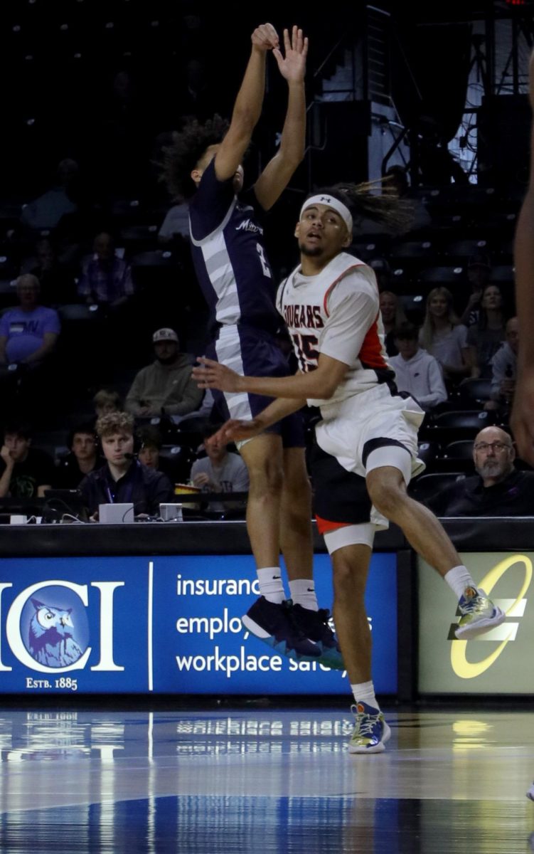 Mid air, junior JaKhai Carter shoots the ball.