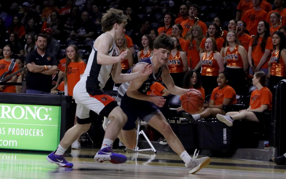 Avoiding a defender, senior Thatcher Ivey dribbles the ball.