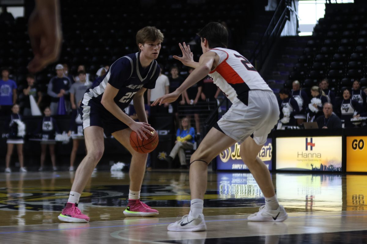 Keeping his eyes on the defender, senior Carter Kaifes looks to drive the ball.