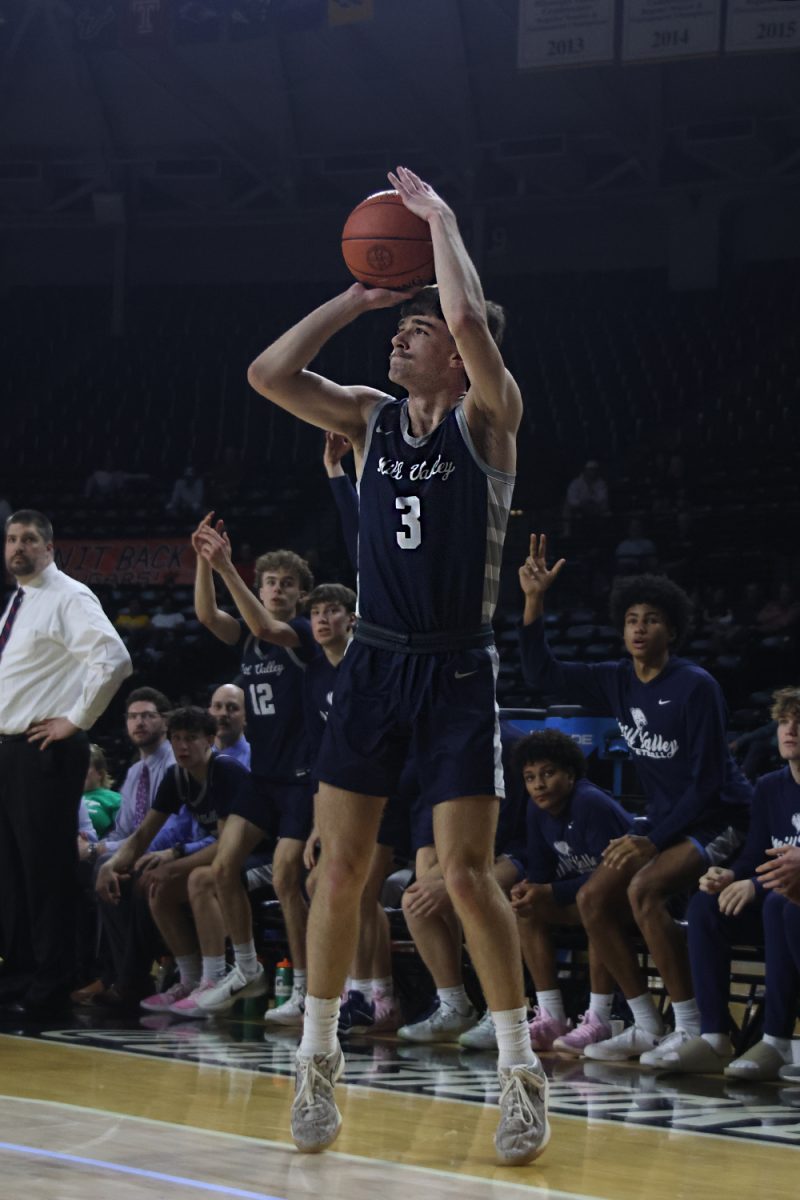 With his eyes on the hoop, senior Thatcher Ivey shoots a 3-pointer.