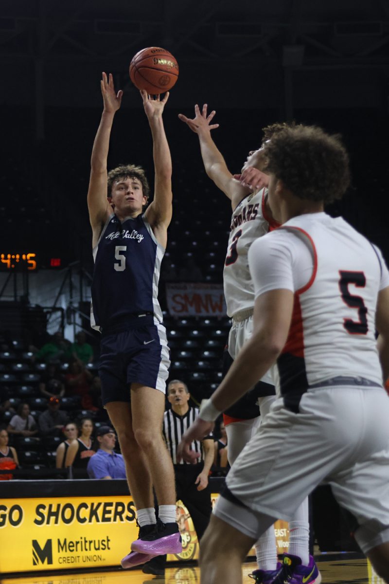 Junior Reece Riedel shoots the ball over his defender.