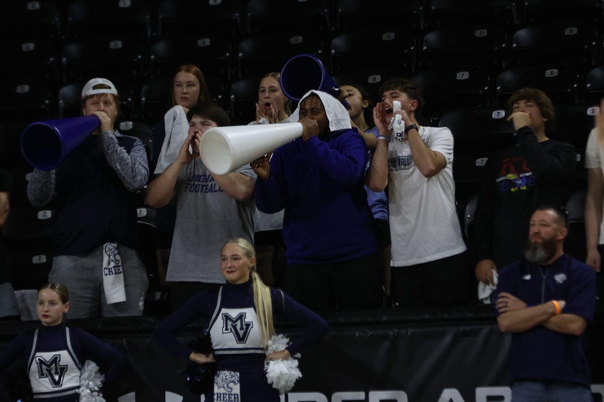 Yelling a chant, the student section shows their support for the Jags.