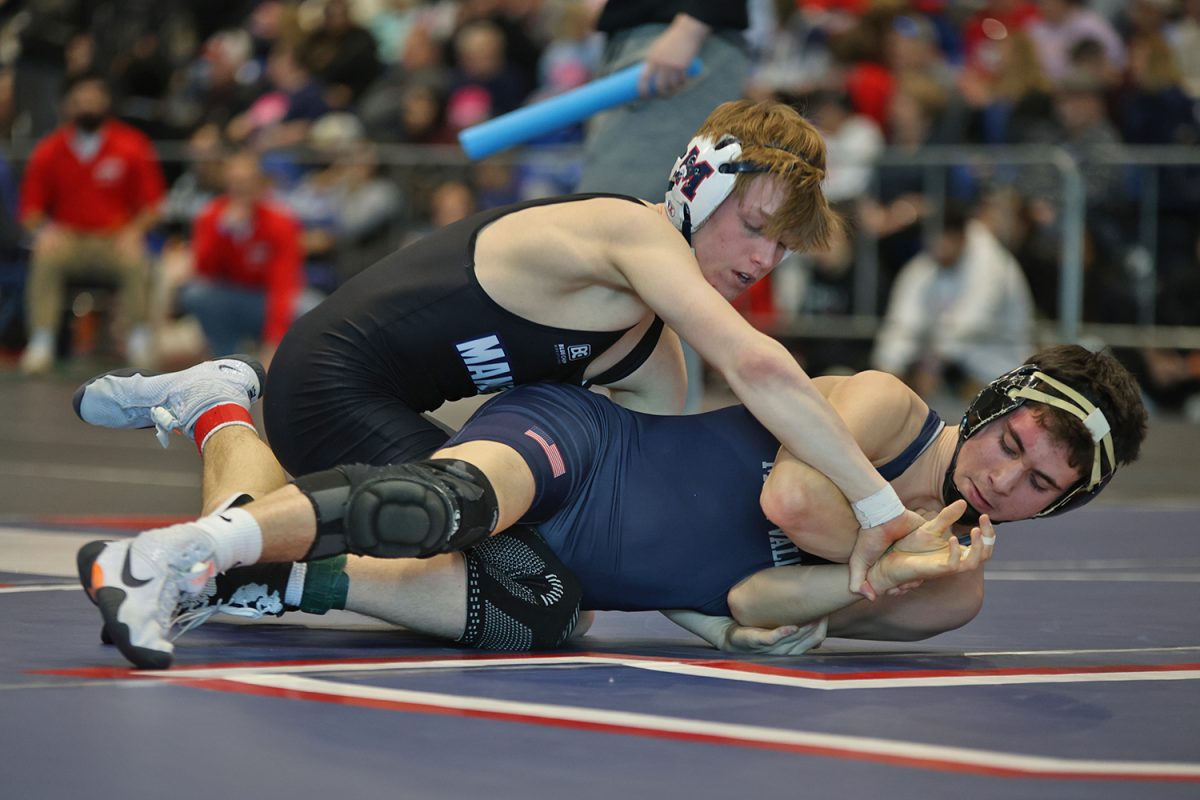 Focused, sophomore Ethan Leon fights his opponents hold on his wrist. 