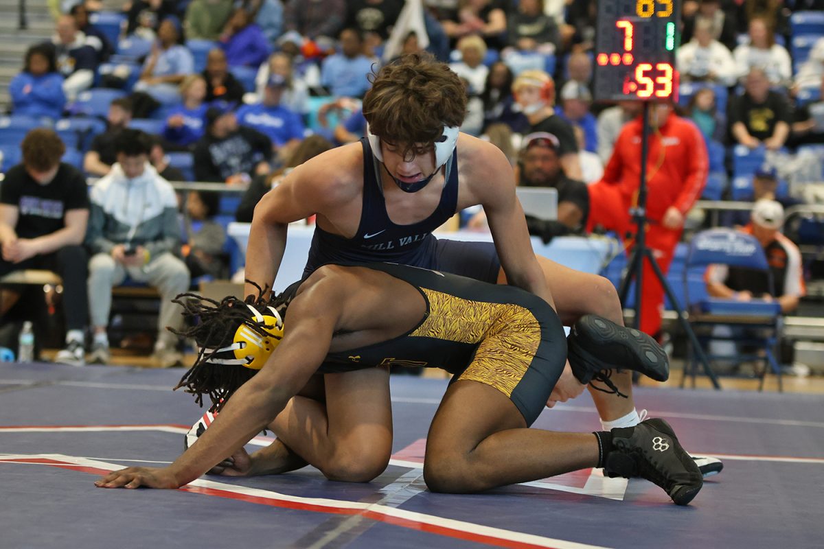 Eyes down, sophomore Quinn Vaka works to roll his opponent onto his back. 