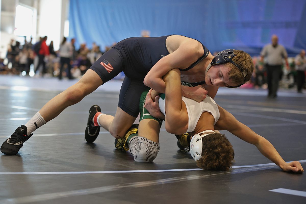 Circling around, junior Jeredy Nilges uses a chicken wing move on his opponent.