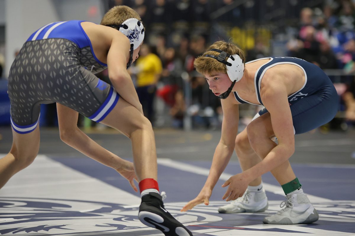 Eyes on his opponent, freshman Liam Grover squares off in the start of a match.
