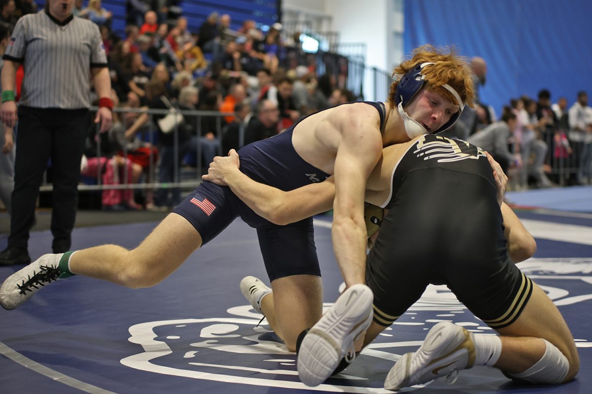 Going for a takedown, sophomore Billy Gadwood reaches around to grab his opponent's ankle.