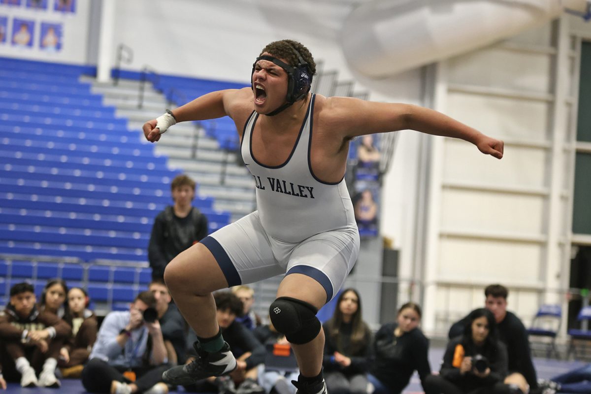 In mid air, junior Lamarcus Barber celebrates after qualifying for the finals match. 