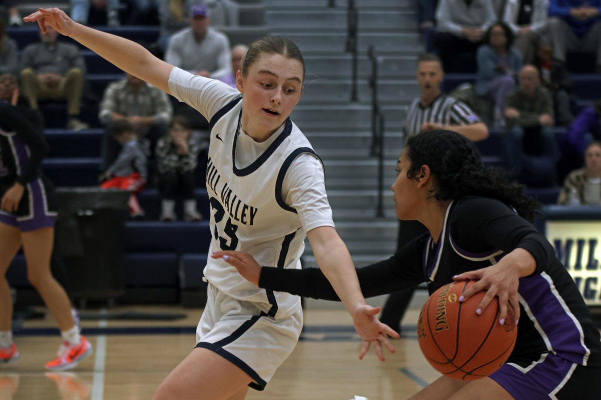 Sophomore Riley Marshall reaches for the ball from her opponent.