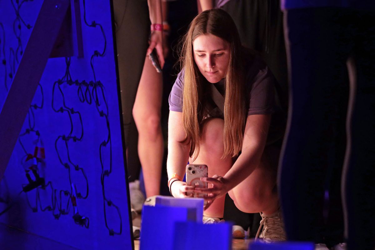 During the Luminaria ceremony, sophomore Molly Hillner takes a photo of one of the Luminaria. 