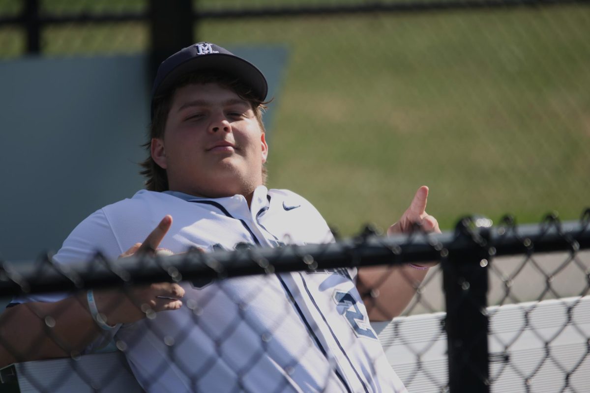 Junior Ryan Gleason takes a seat while watching the game