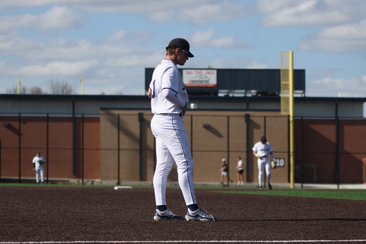 Looking at the batter, junior Drew Yockey waits for the pitch to be thrown