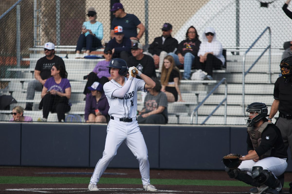 Looking towards the pitcher, senior Hudson Powers readies himself