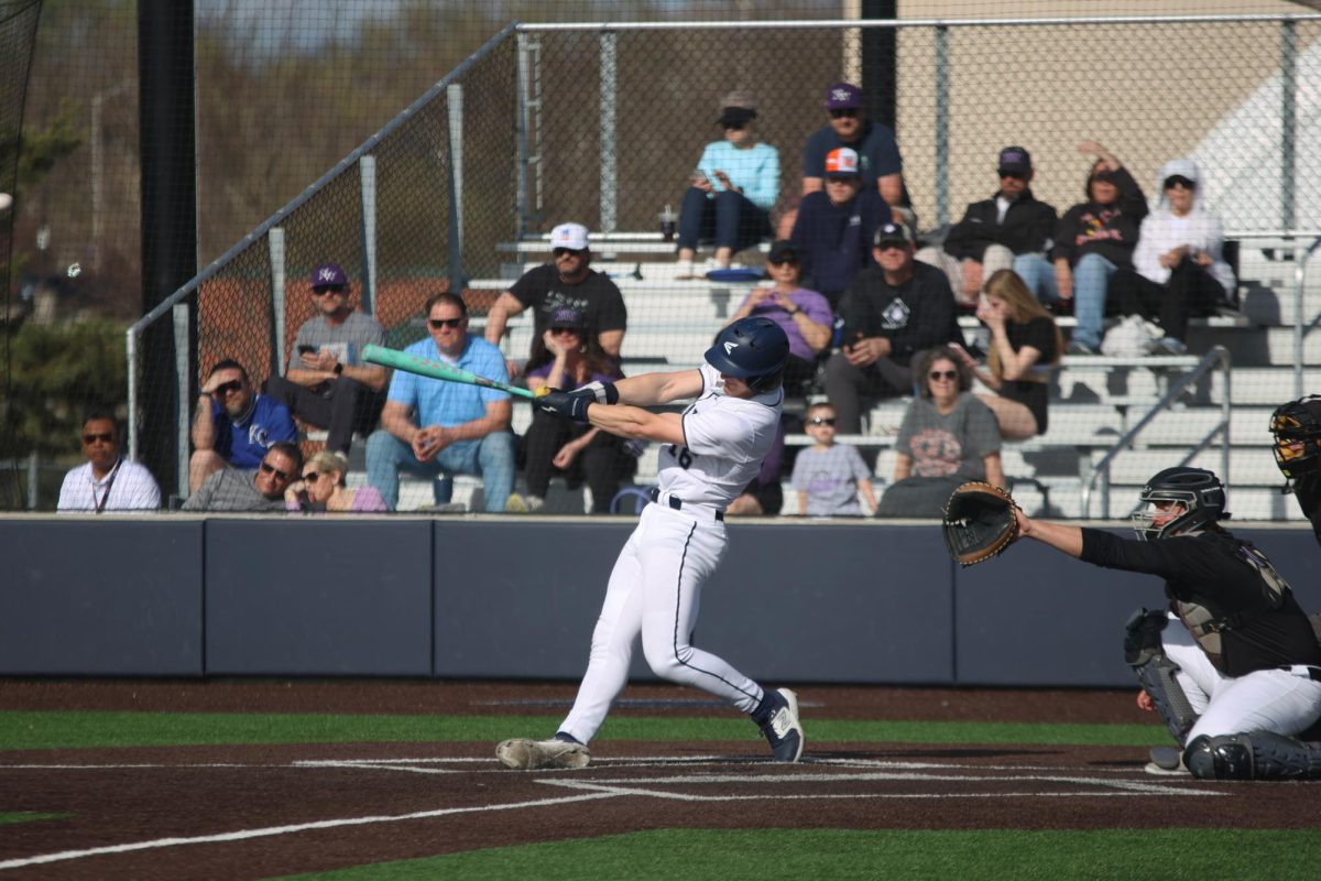 Taking a big swing, junior Beau Peterson uses all of his strength