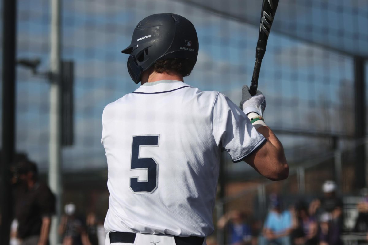 While on deck, senior Connor Bohon takes notes of what the opposing pitcher is throwing