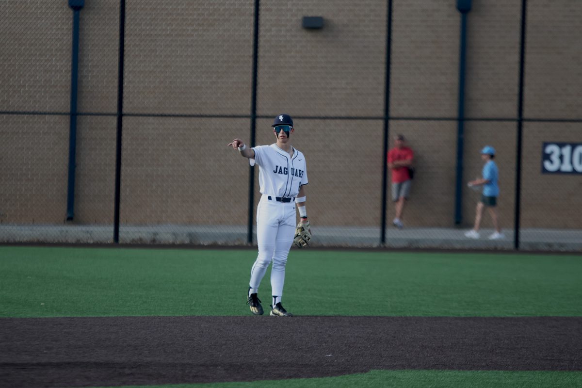 Junior Blake jay points to his teammate communicating the play