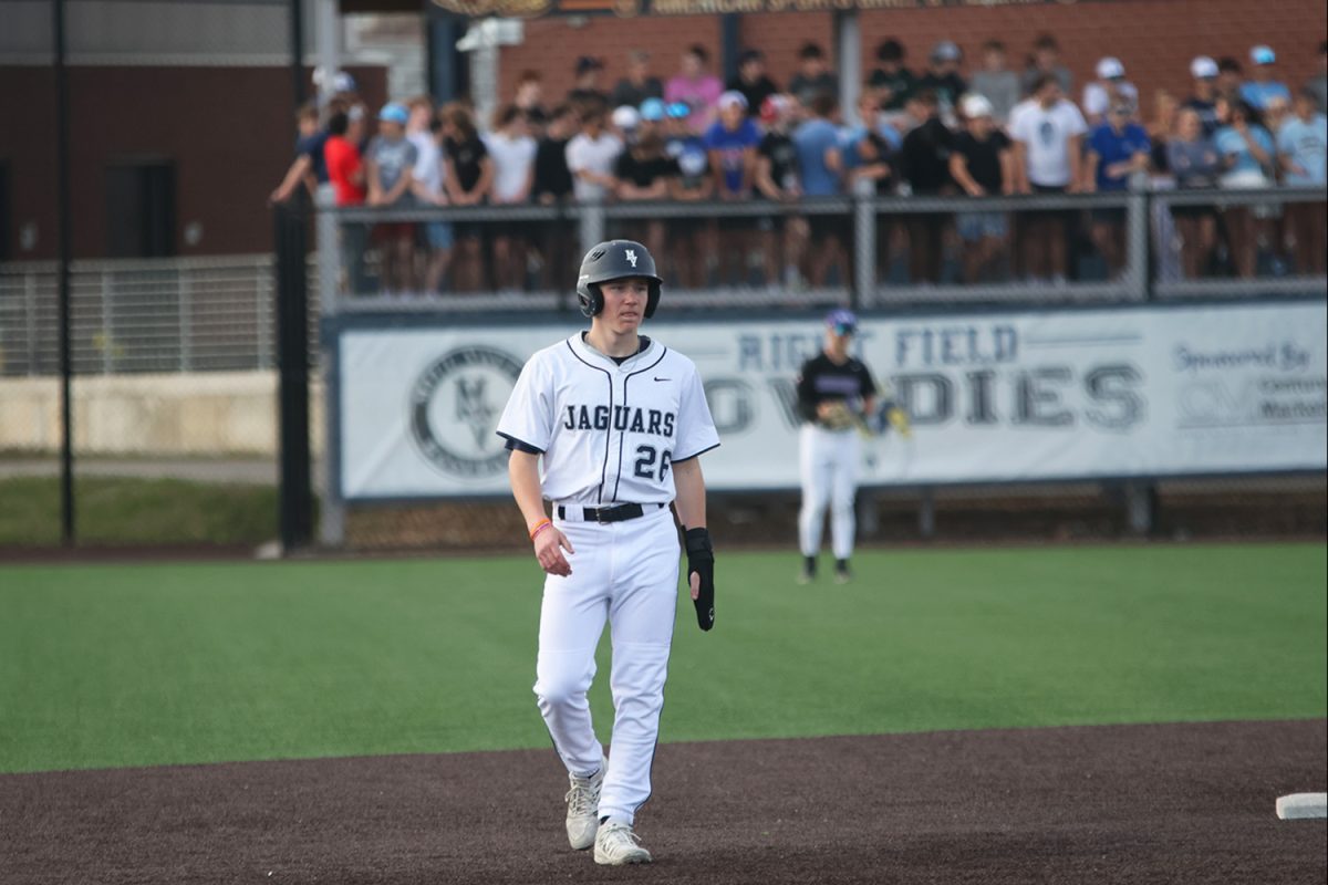 Taking his lead off of second base, junior Dylan Mothersbaugh looks to his coach