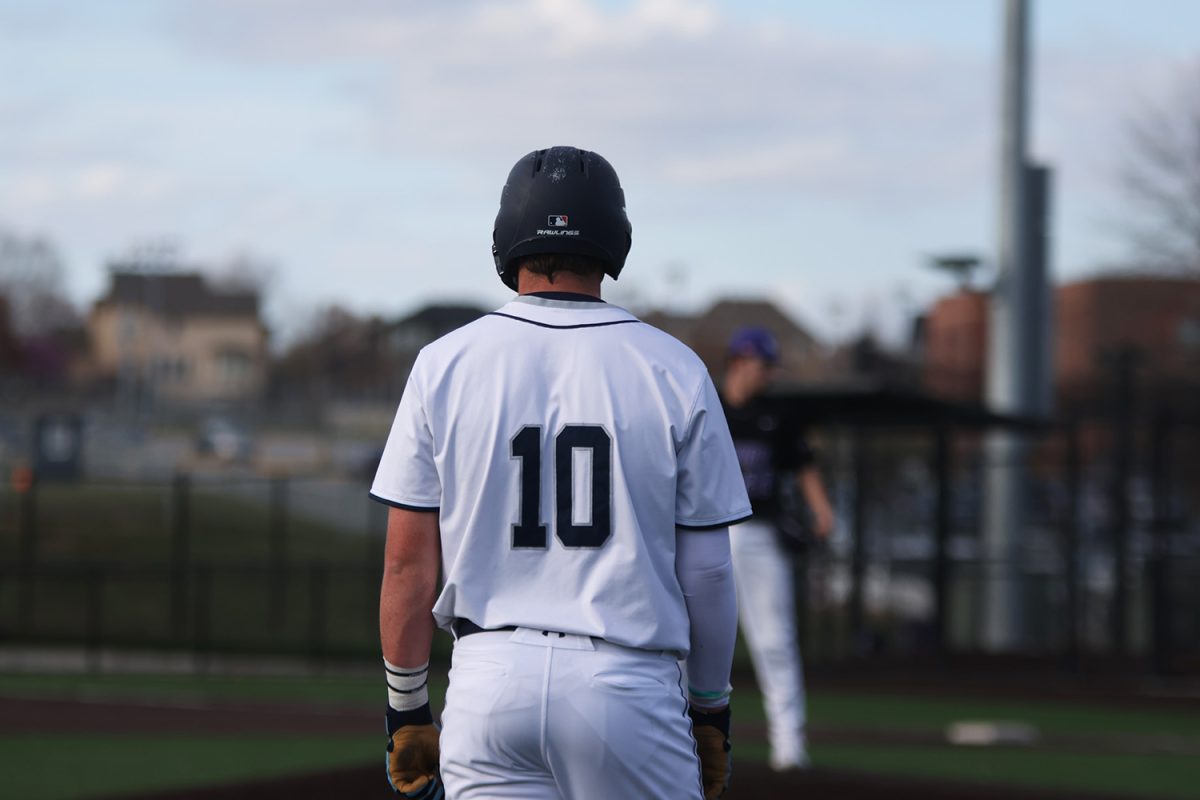 Watching the pitcher, junior Drew Yockey takes his lead off third base