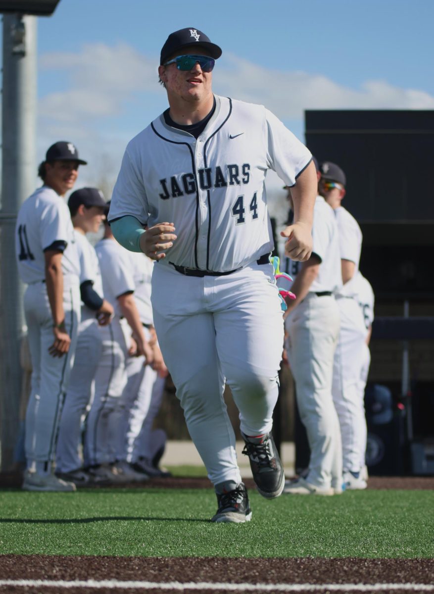 Sophomore Easton Engelhart runs to the field after his name is announced