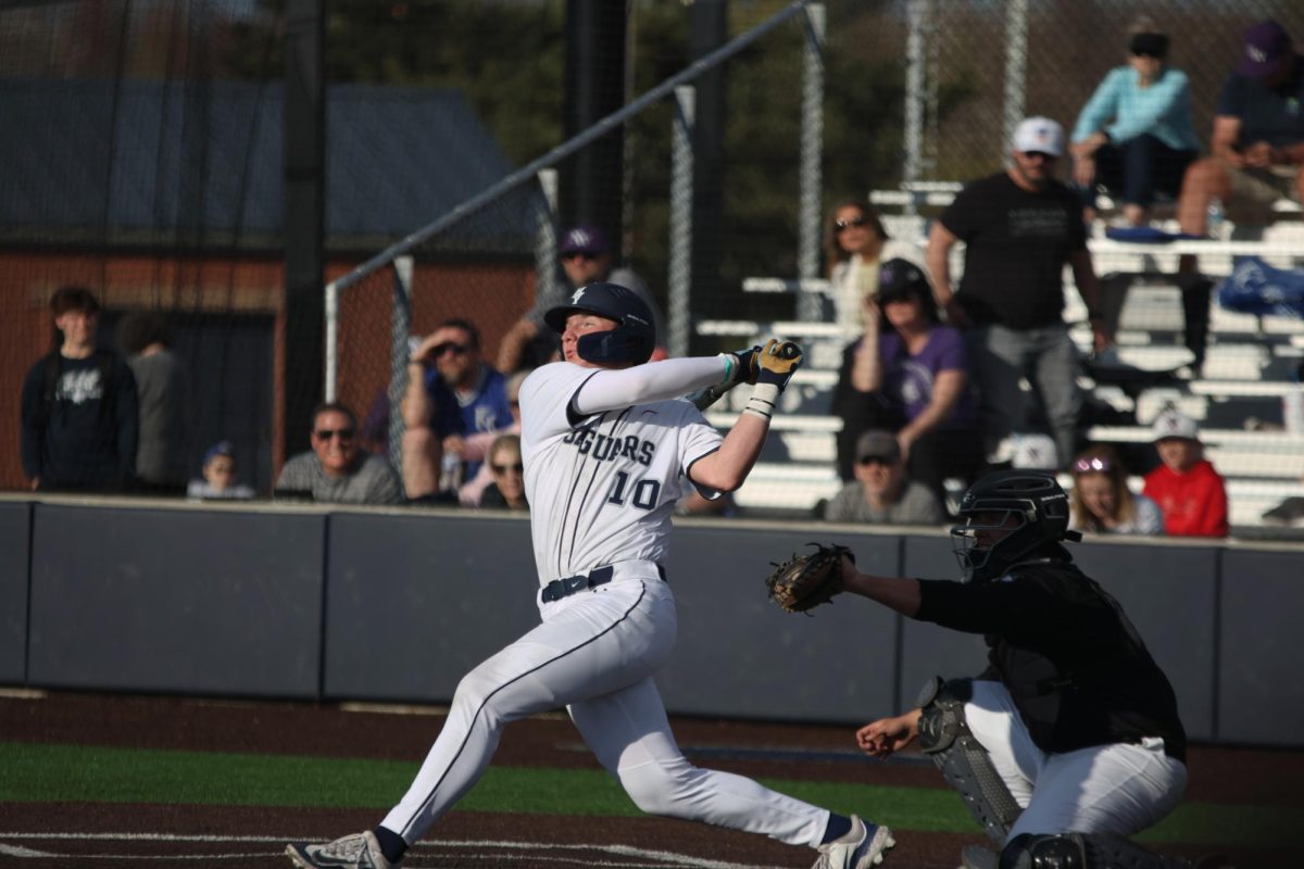 Swinging hard, junior Drew Yockey blasts a home-run over the left field fence