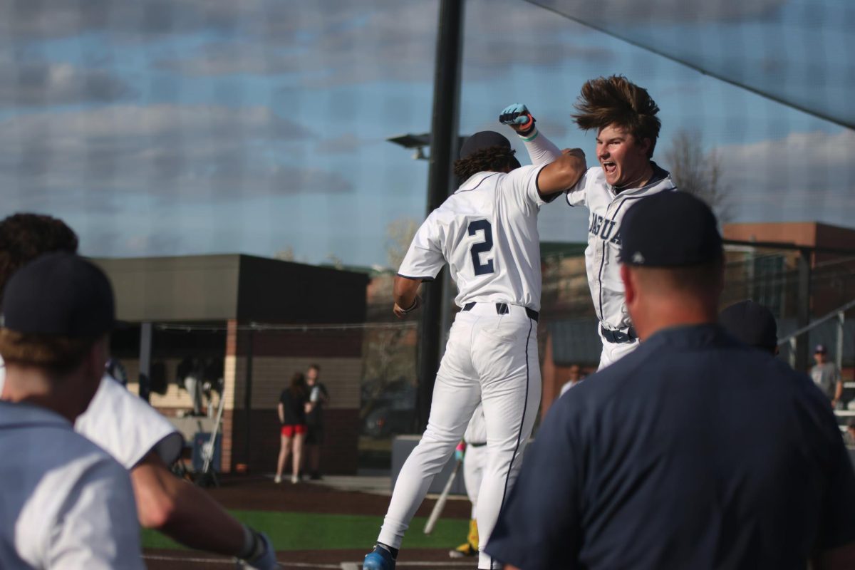 Junior Drew Yockey and senior Terran Marshall jump together in celebration