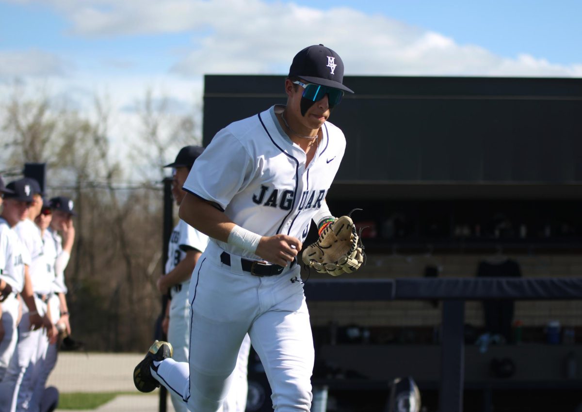 Junior Blake Jay runs out onto the field