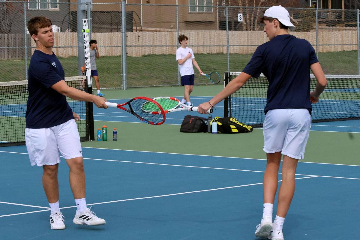 Sophomore Jace Hutchens and junior Jack Thomas celebrate after a point. 