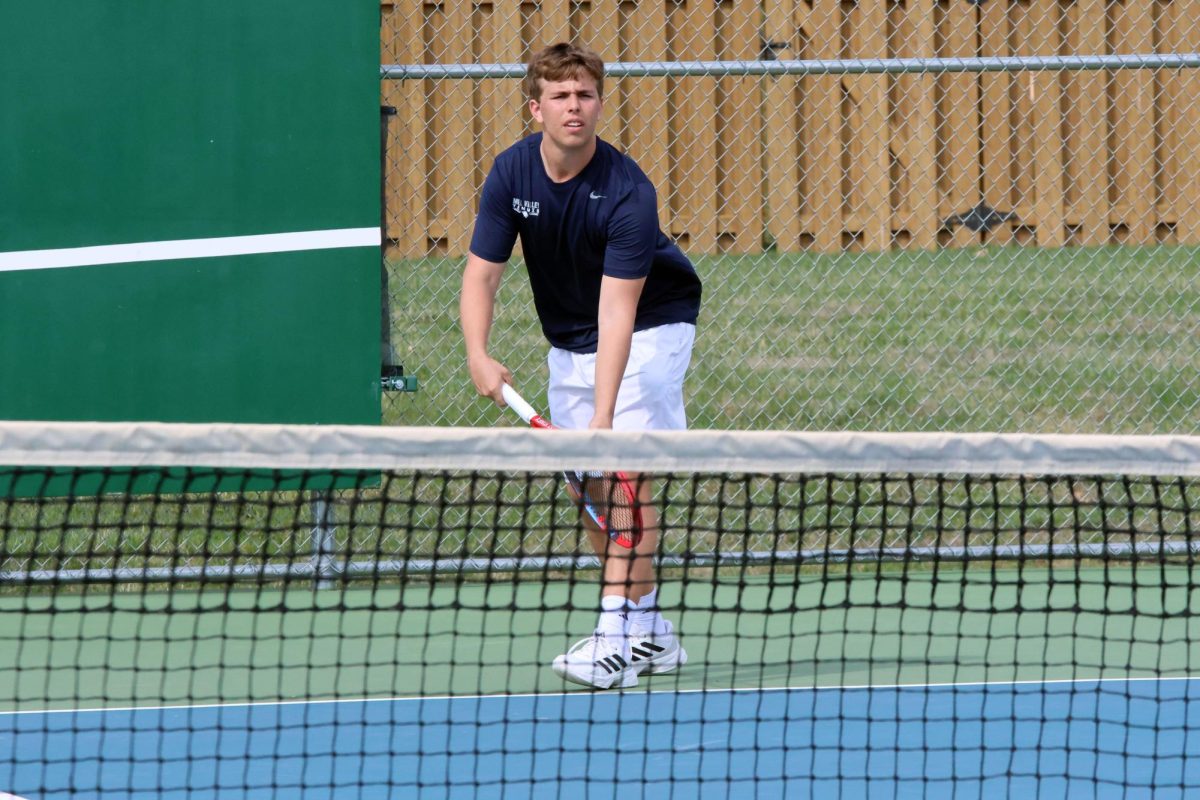 Junior Jack Thomas serves the ball to his opponent.  