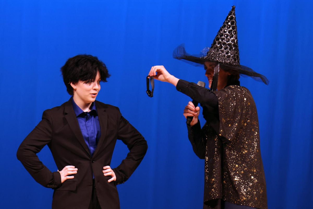 Holding out a watch, junior Nate Petrowsky attempts to hypnotize junior Oliver Feiring.