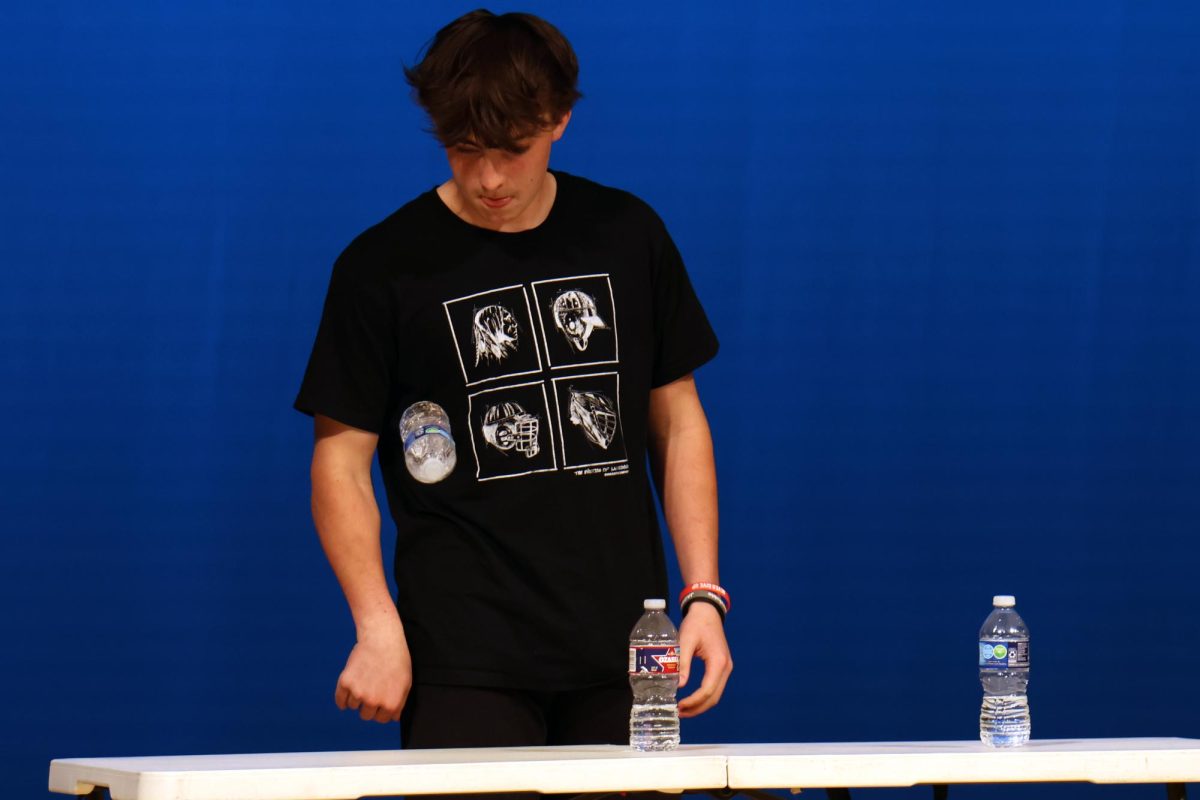 With precision, freshman Stuart Lovejoy performs bottle flips for his talent.