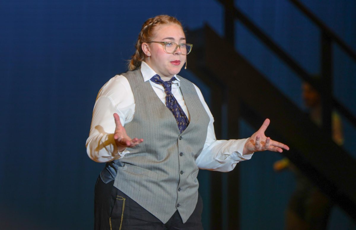 Facing the audience, the Stage Manager, played by senior Lillian Schleicher, breaks the fourth wall. 
