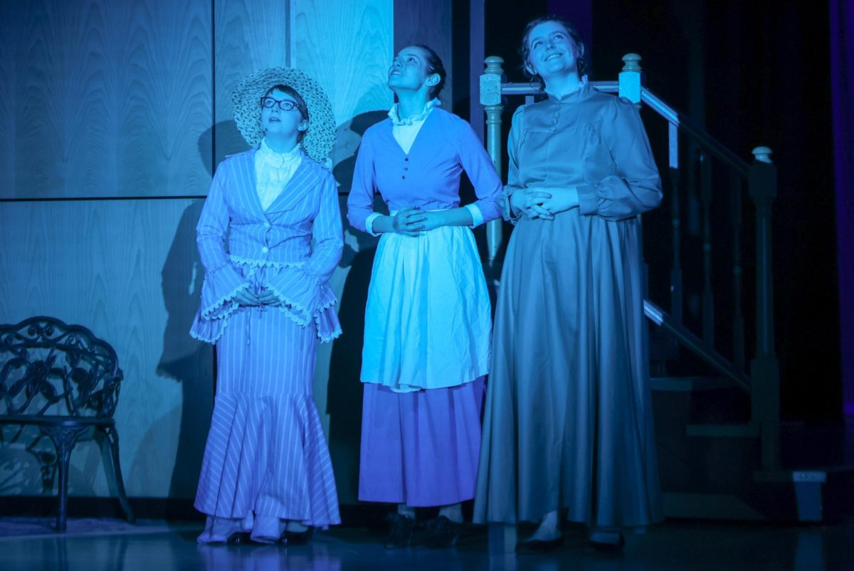 Looking towards the sky, characters Mrs. Webb, Mrs. Gibbs, and Mrs Soames, played by junior Josey Crossley and seniors Christina Baumgart and Lilly Rugenstein, admire the moon.
