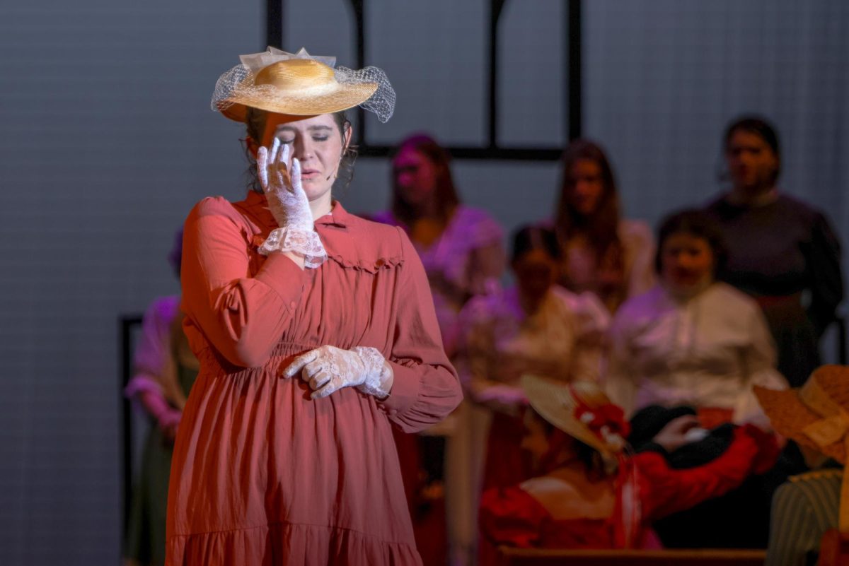 Whipping her tears, Mrs. Webb, played by junior Josey Crossley, watches as her son gets married.
