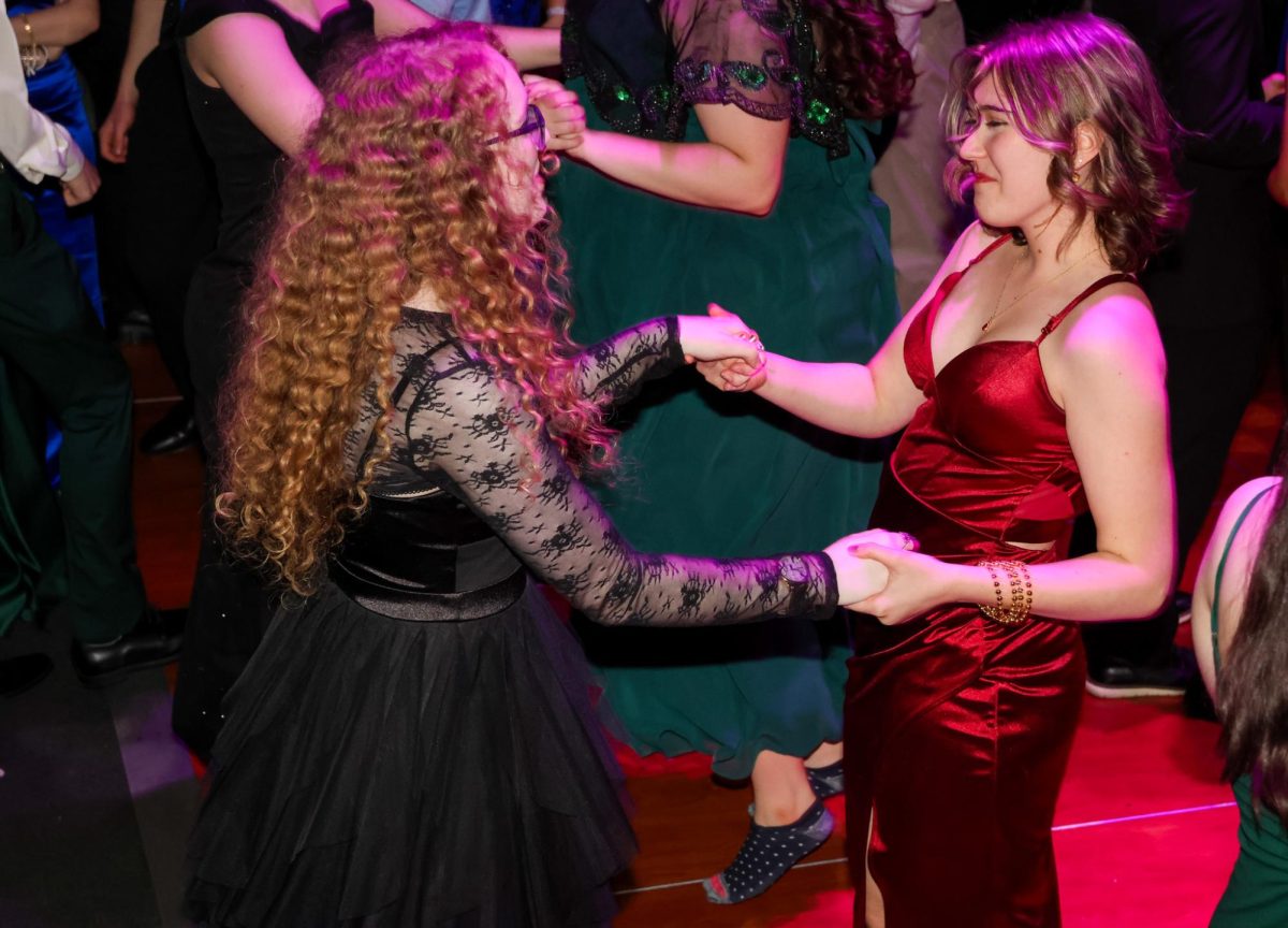 Together, juniors Maddison Davied and Kaitlyn Shinkle dance across the floor.
