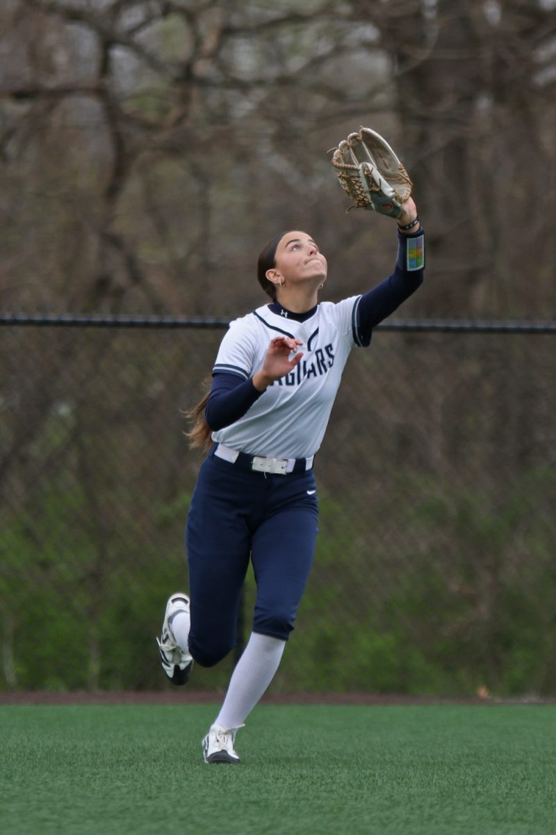Looking up, junior Kinley Ruder moves toward a pop fly ball.