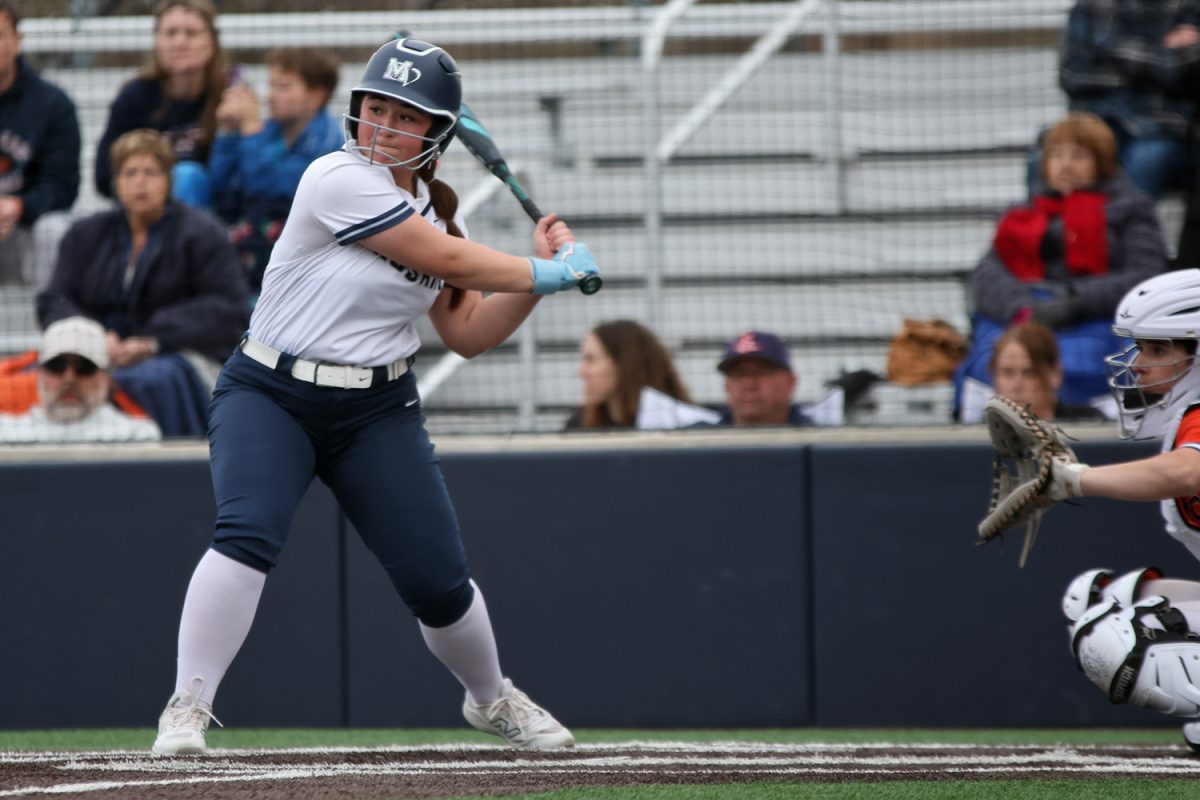 Eyes on the ball, freshman McKenna O'Leary starts her swing. 