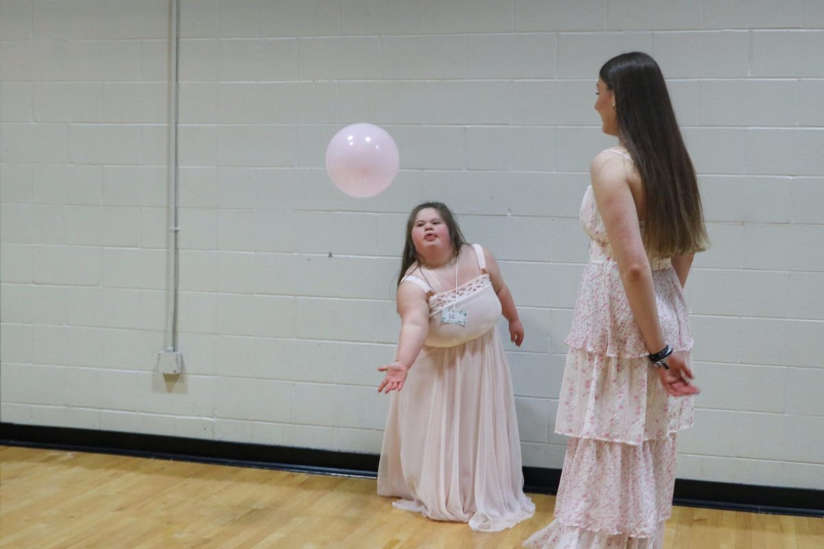 At prom, LC and Sophomore Darby Hawkins play with a balloon.