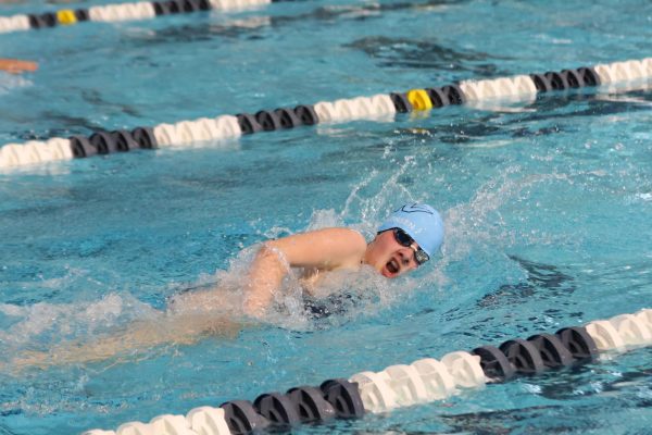 Coming up for air, junior Hannah Stephensen finishes her lap for the 100Y freestyle.