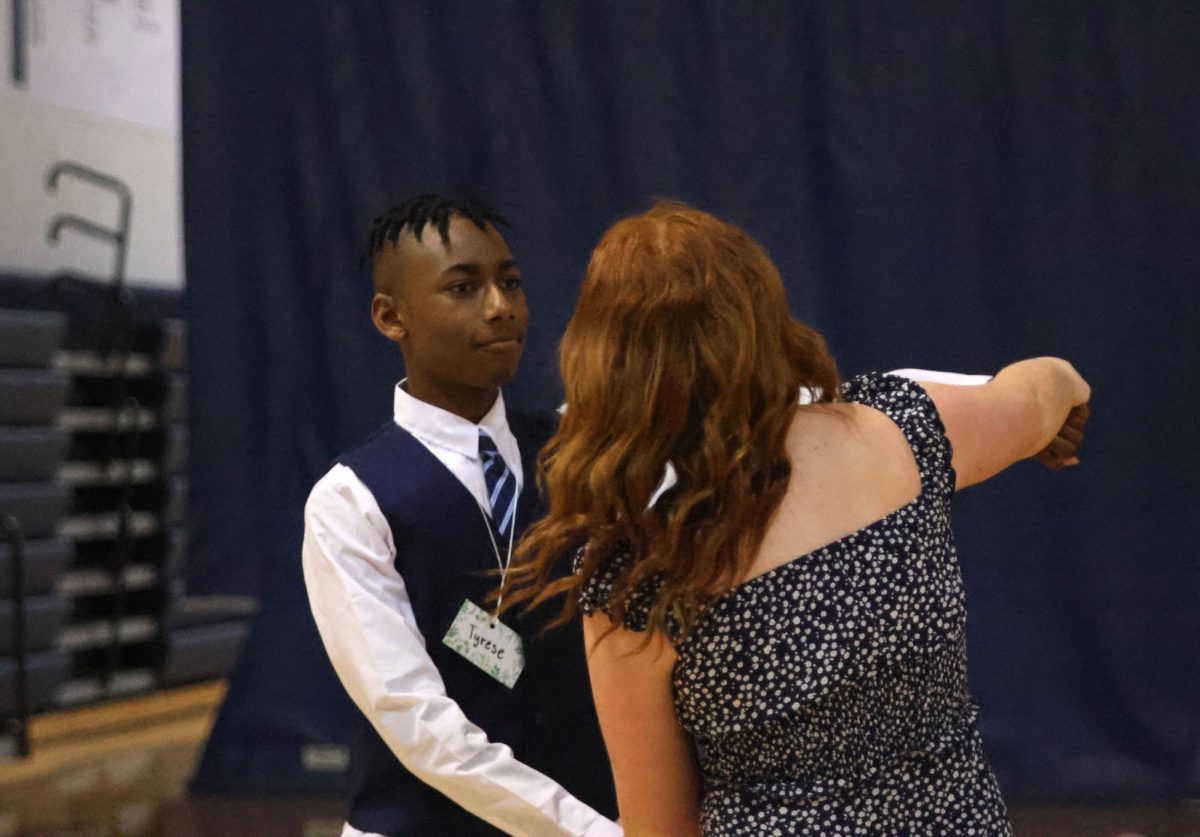 Dancing together, sophomore Hadley Doyle and freshman Tyrese Davis swing their arms. 