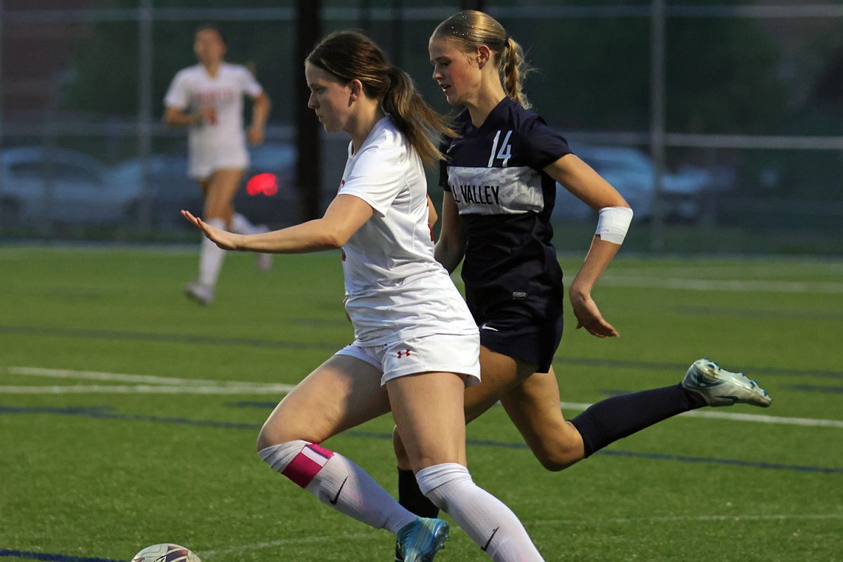 Catching up to her opponent, senior Calista Marx chases her opponent with the ball. 