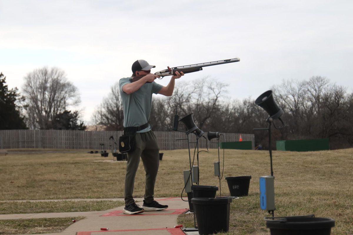 Senior Owen Kalma aims high to hit his target as it flies through the air during his practice on Friday, March 7.
