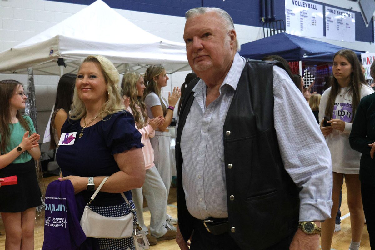 Completing the survivor walk, social studies teacher Tina Keith walks with her father.