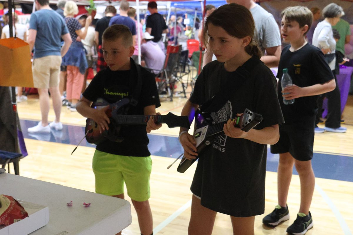 Two Relay For Life participants focus on their guitar playing. 