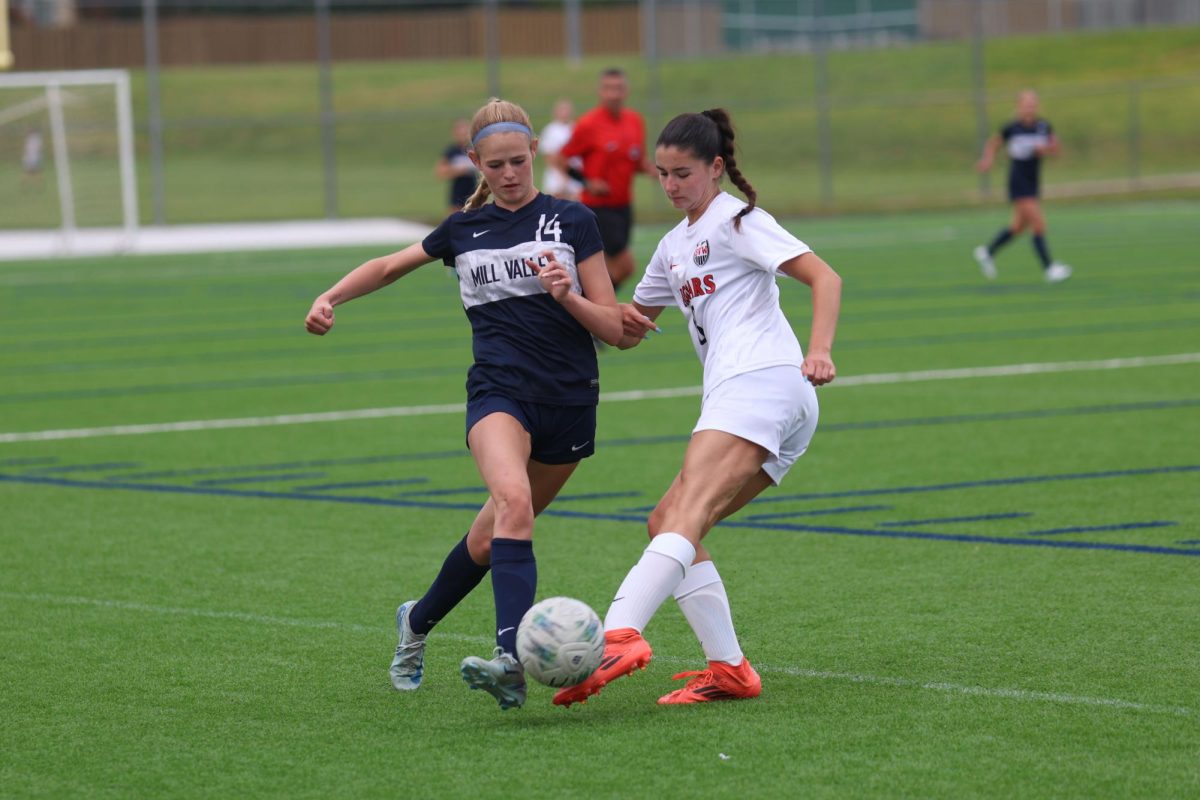 Eyes on the ball, senior Calista Marx moves the ball past an opponent.
