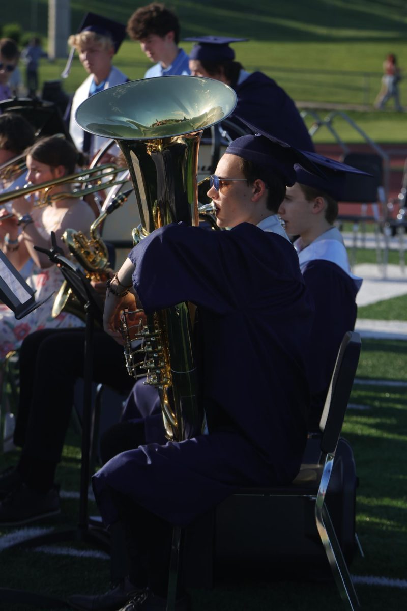 Sitting down, senior Zane Lauer plays the tuba in symphonic band.
