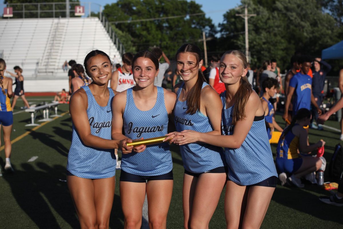 The girls 4x100 meter relay poses for a photo after breaking the school record.