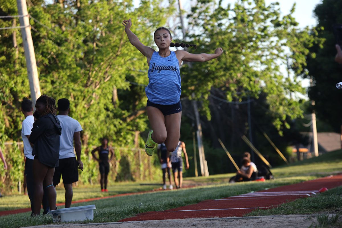With her eyes on the sand, senior Alonnah Gage competes in long jump. 